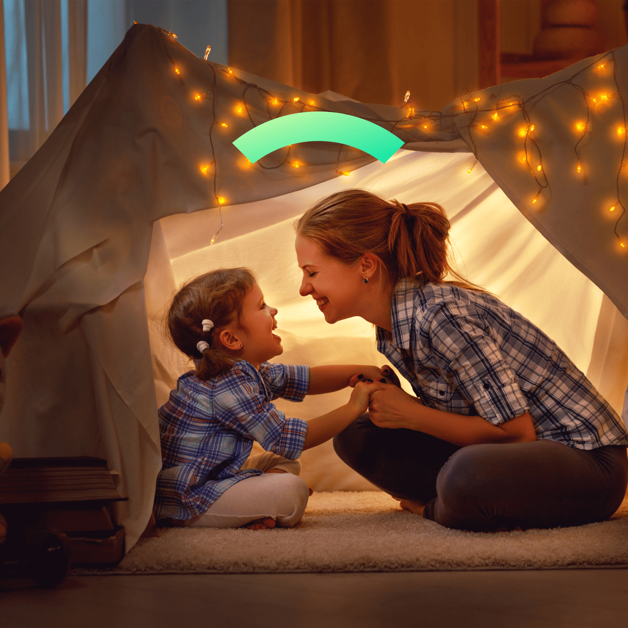 A mother and her young daughter play in a fort. They're Covered.