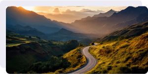 A road cuts through a mountainous landscape.